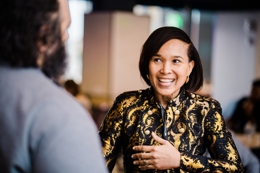Photo of a woman in conversation with someone out of frame.