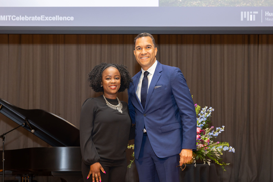Farrah Belizaire and John Dozier standing with a piano and flower arrangement behind them.