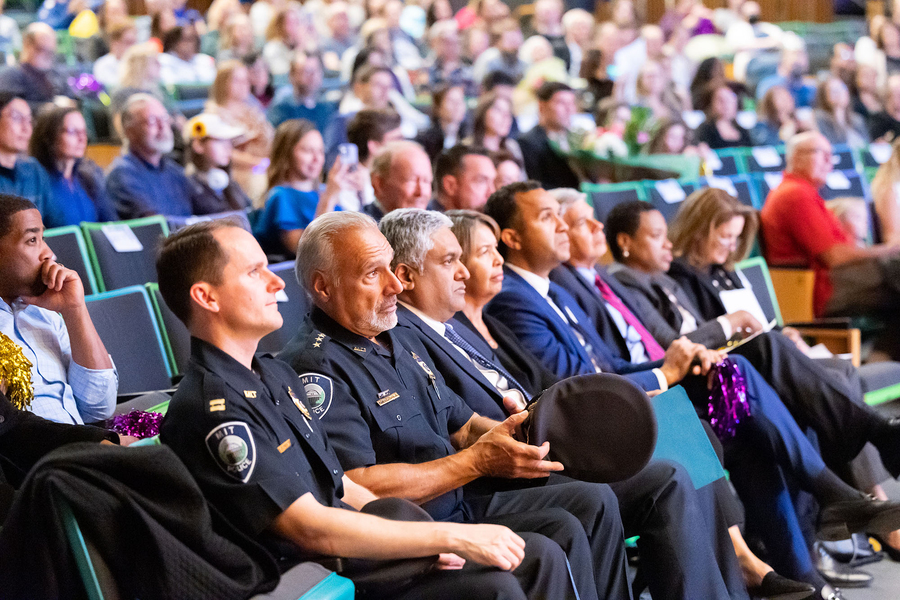 A row of adults sitting in an auditorium.