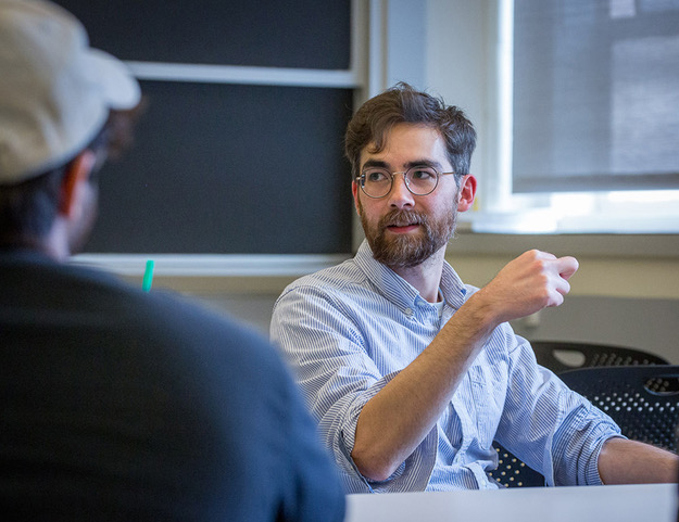 Associate professor of philosophy Justin Khoo speaks to students in his Philosophy of Film course.