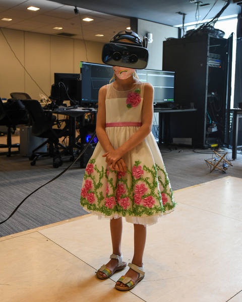 A young girl wears a virtual reality headset