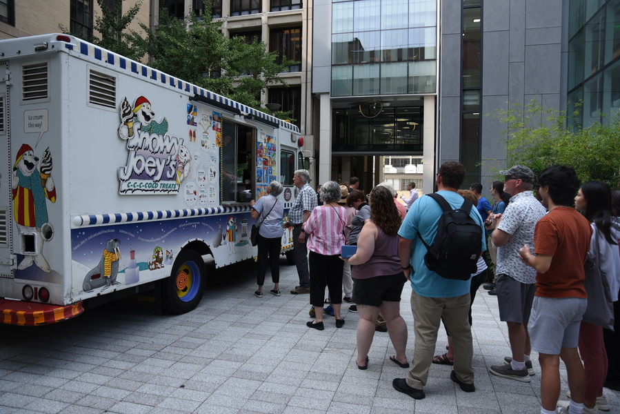 A line of people standing alongside an ice cream truck called Snowy Joey’s