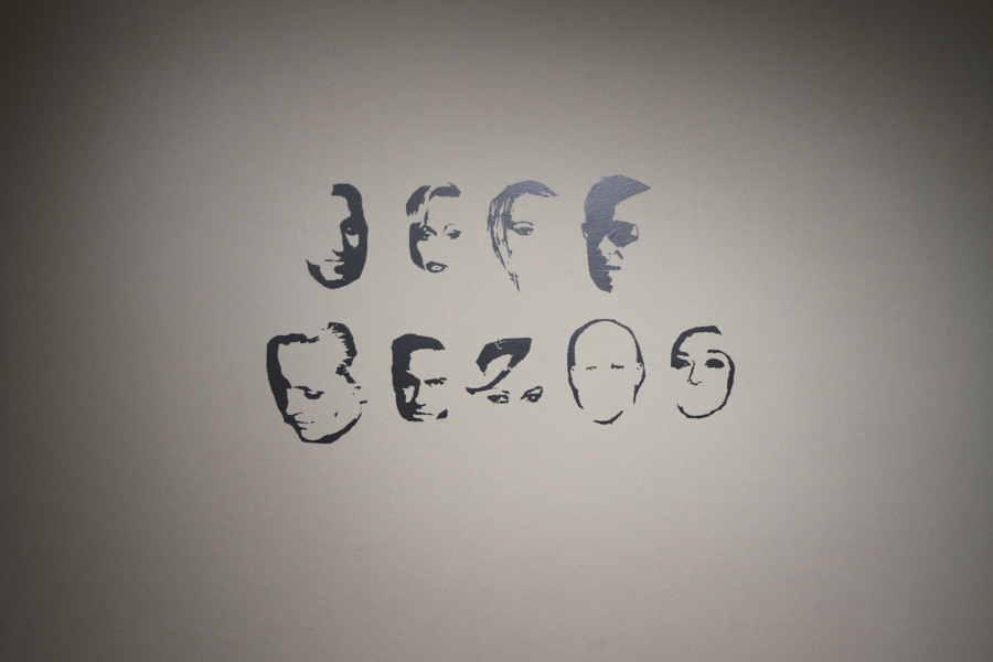 Black letters formed by partly erased celebrity faces write the words "Jeff Bezos.”