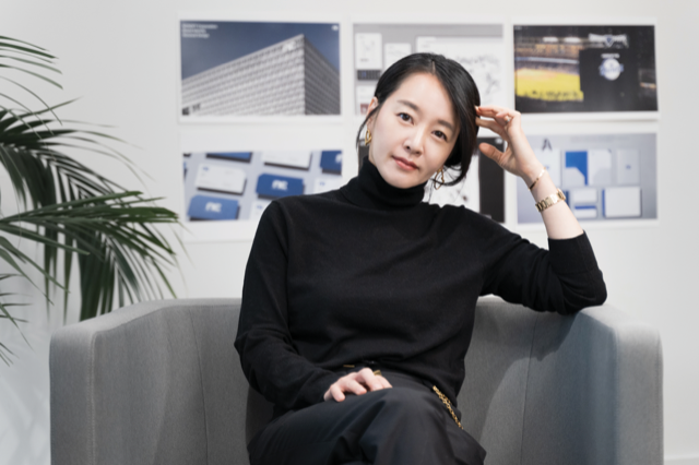 Portrait photo of Songyee Yoon sitting in a small office