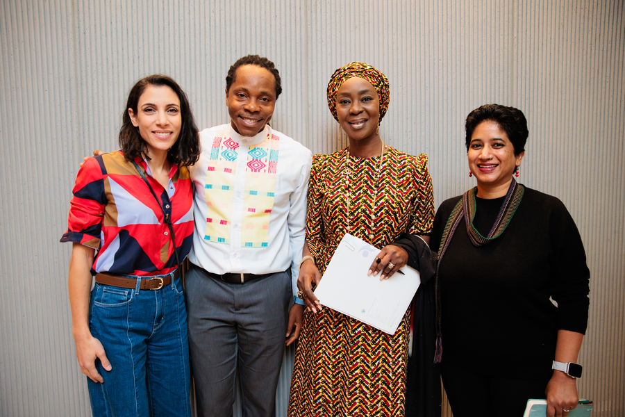 Hala Hanna, David Sengeh, Toyin Saraki, and Lysa John pose together in front of a light gray wall indoors.