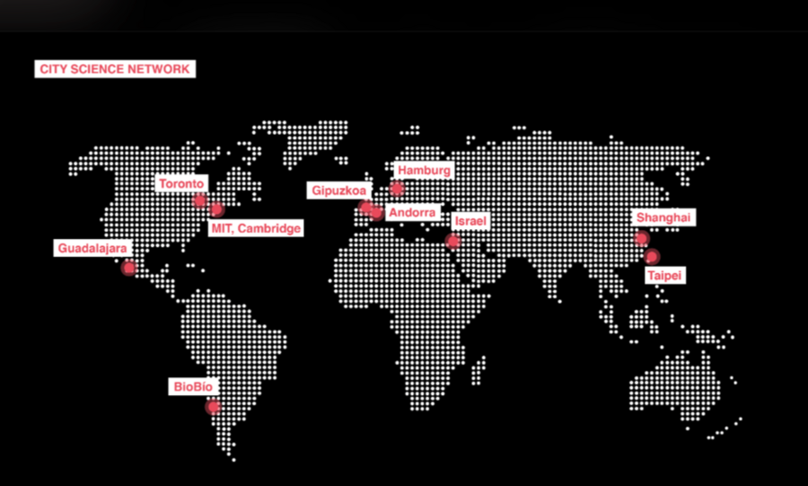 A world map made up of white dots on a black background, with red dots and labels showing each of the "nodes" in the City Science Network: MIT, Toronto, Guadalajara, Bióbió, Hamburg, Gipuzkoa, Andorra, Israel, Shanghai, and Taipei. 