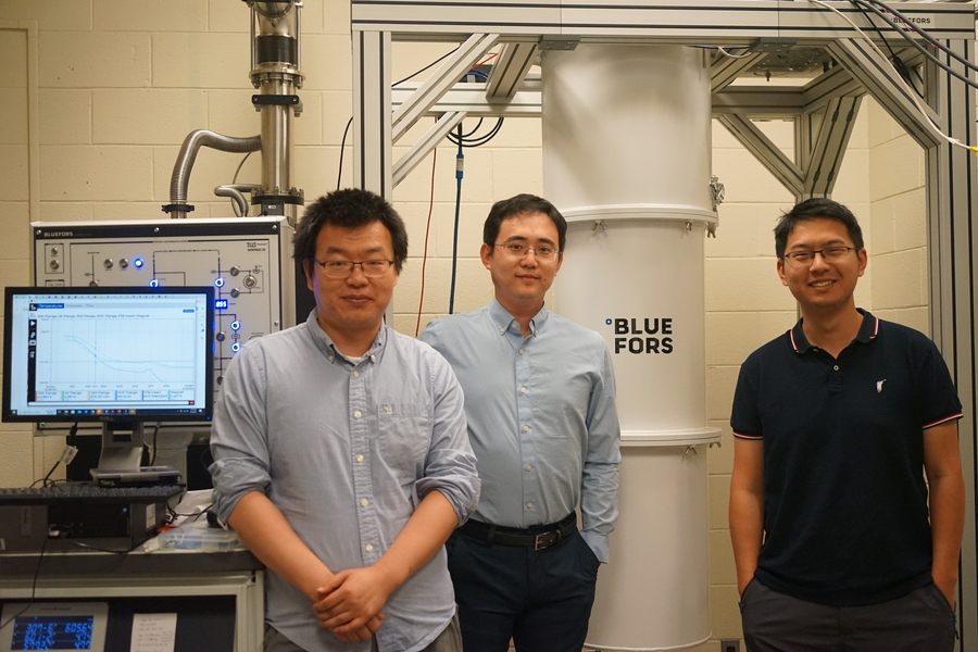 Zhengguang Lu, Long Ju, and Tonghang Han pose standing in the lab