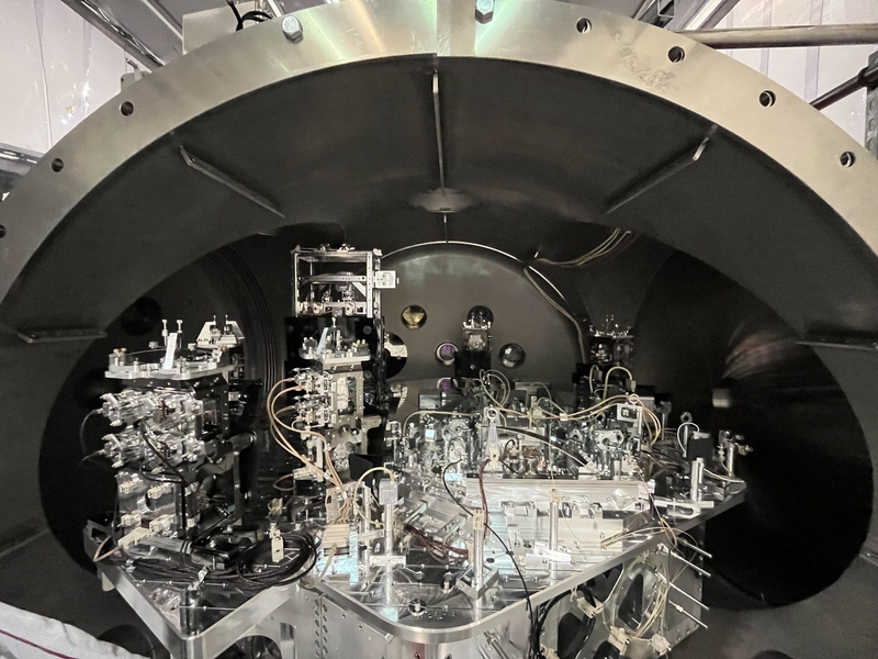 A side view of the LIGO instrument shows its curved ceiling, and some parts of the instrument are taller and stacked.