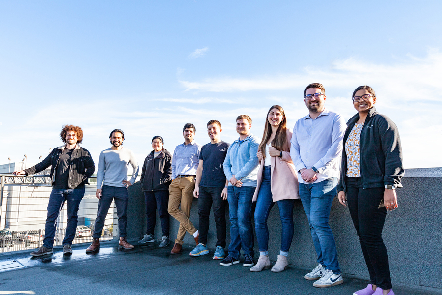 A group photo of 9 members of the Noya team outside on a deck, including Josh Santos, second from left.