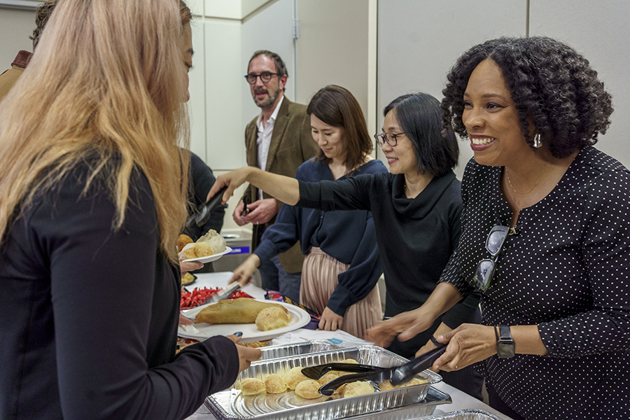 Nilma Dominique serves food to students.