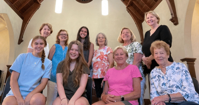 One row of six women standing, one row of four women seated
