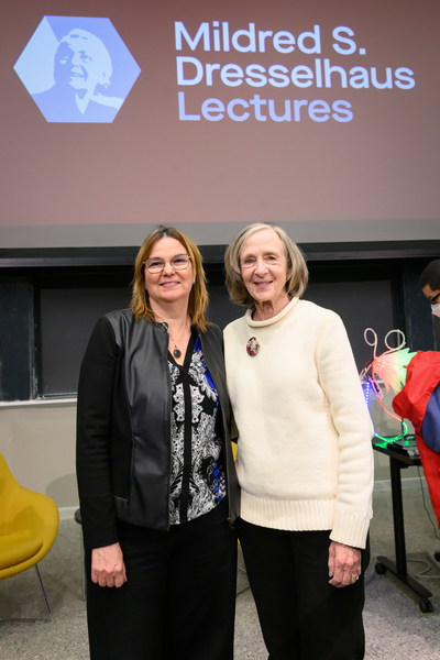 Angela Belcher and Susan Hockfield stand side-by-side for a photo. A screen with "Mildred S. Dresslhaus Lecture" appears behind them.