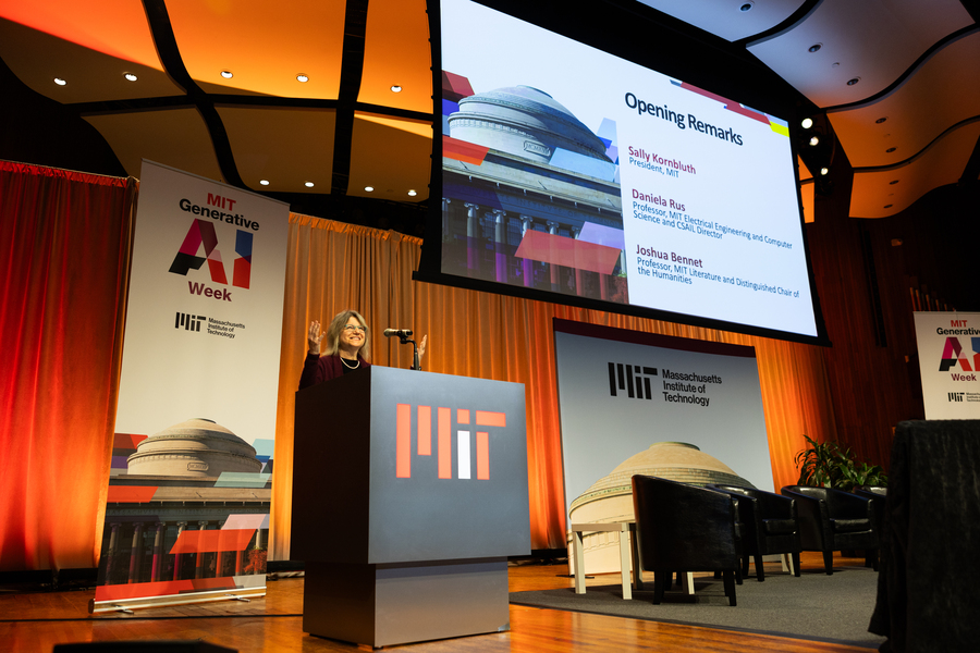 MIT President Sally Kornbluth stands at podium with MIT logo on stage at Kresge Auditorium