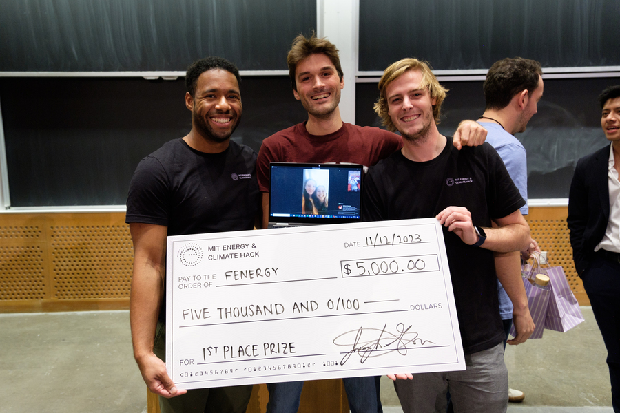 Robbie Lee V, Alessandro Fumi, and Amaury De Bock hold a giant cardboard check made out to “Fenergy” in the amount of $5,000