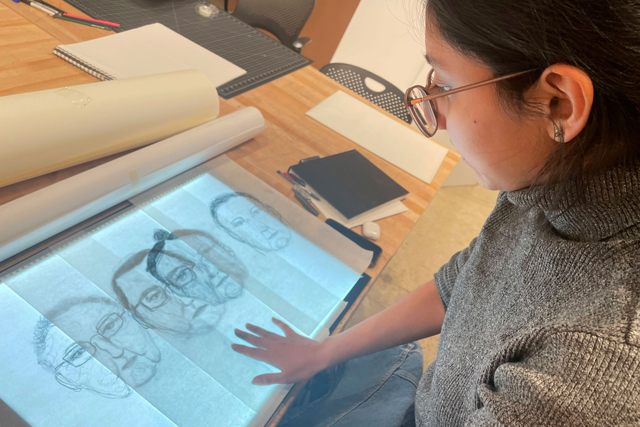 B’ella Ixmata Schaaf examines drawings of her family members on a light table.
