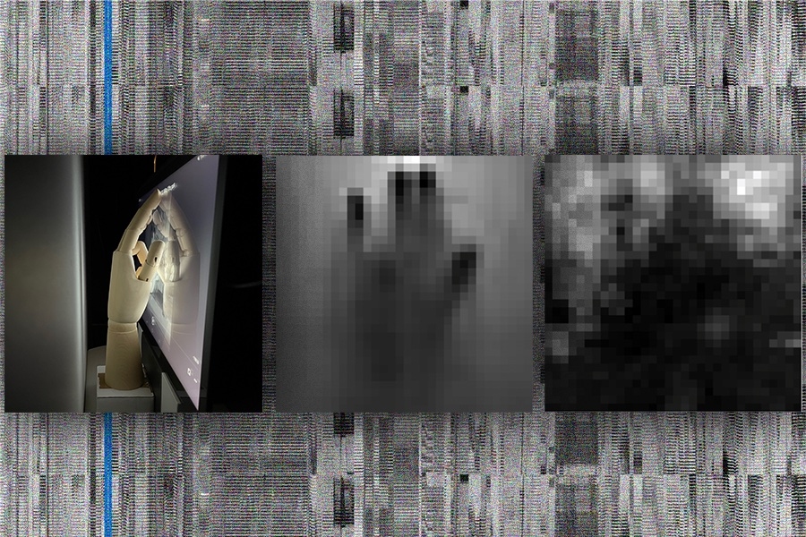 Three squares over black-and-white pixels resembling television static: Left side contains a brown mannequin’s hand tapping a phone screen with its ring finger down in a dark room; at center is a grayscale pixelated image of that gesture; at right is a grayscale, more pixelated image of the gesture.