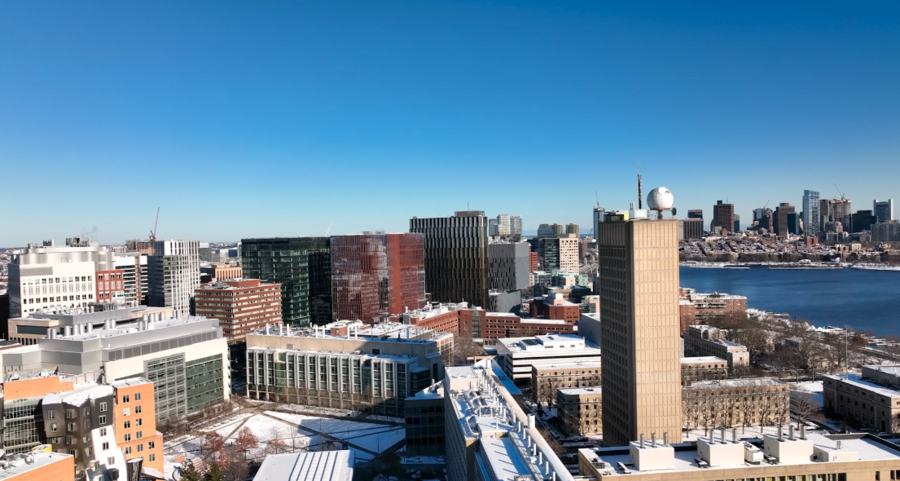 A drone's view of a snowy MIT campus with Boston skyline in background