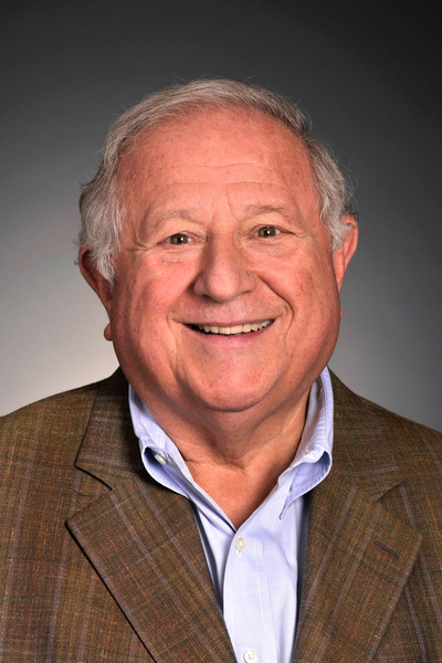 Headshot of Ed Roberts with a gray background.