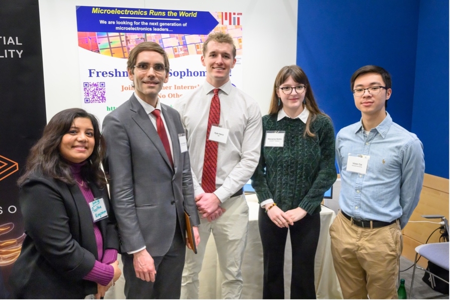 a group of five people wearing nametags standing together