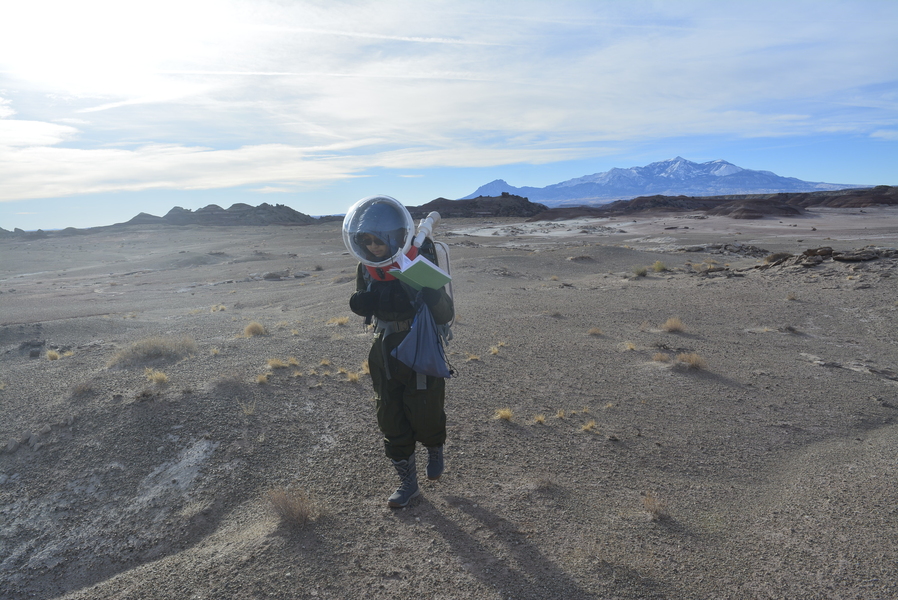 Wing Lam (Nicole) Chan walking through the Utah desert in her EVA suit