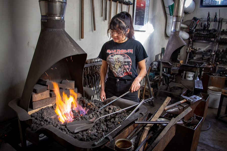 Amber Velez working a piece of metal in MIT’s forge