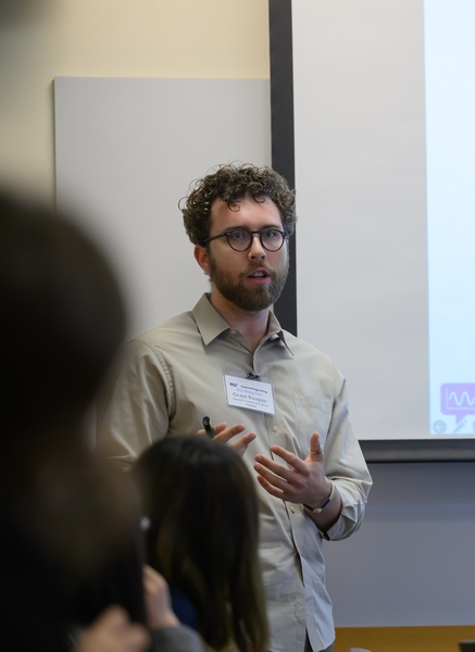 A photo Grant Knappe speaking in front of a conference room.