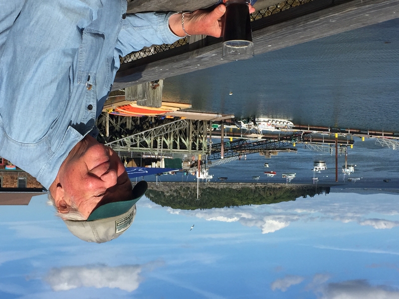 Professor Emeritus Bernhardt Wuensch at a railing overlooking the water at Bar Harbor in Maine.