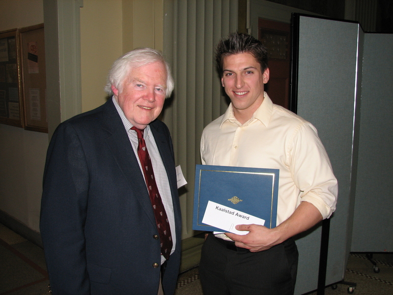 Jerome Connor poses with a student holding a certificate