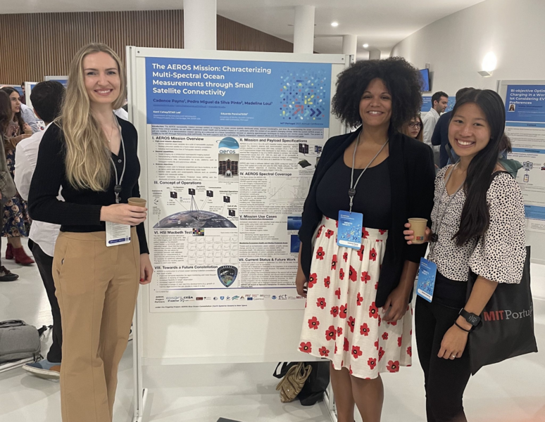Annika Thomas, Cadence Payne, and Madeline Anderson pose in front of an academic poster