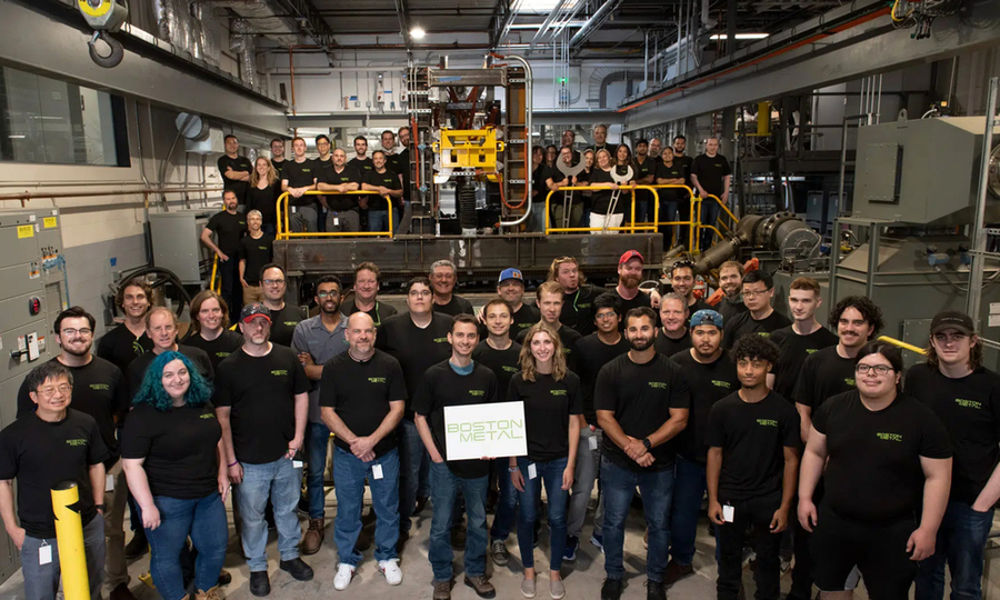 A group photo shows over 50 members of the Boston Metal company.