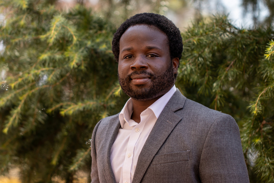 Portrait headshot of Robert Gilliard standing in front of pine trees