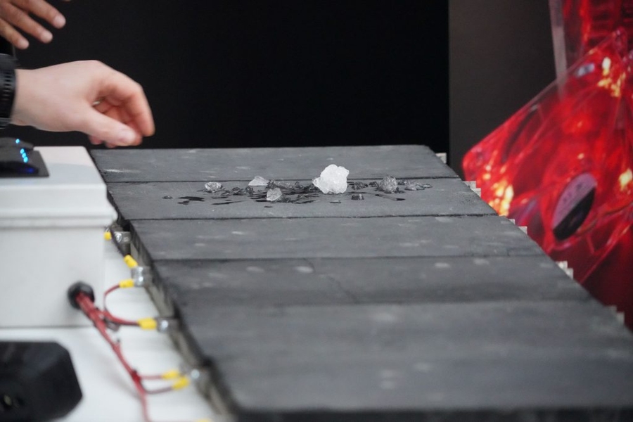 Ice placed on top of a charged conductive cement panel melts due to the higher temperature of the surface.