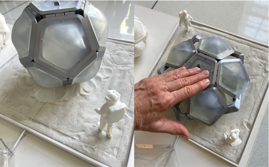 Left image: A tabletop model of astronauts with a geodesic space structure; Right image: a hand presses down to collapse the structure flat.