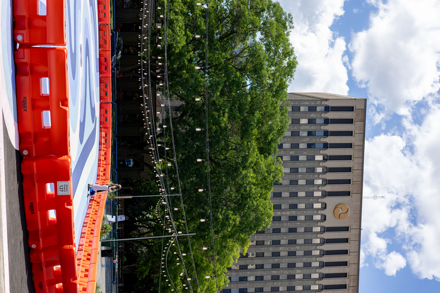 Outdoor roller rink with Volpe Center building in the background