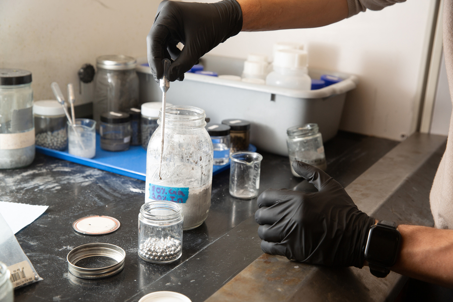 A researcher demonstrates “activating” aluminum by dipping an aluminum pellet in a mixture of gallium-indium. Credits:Photo: Tony Pulsone