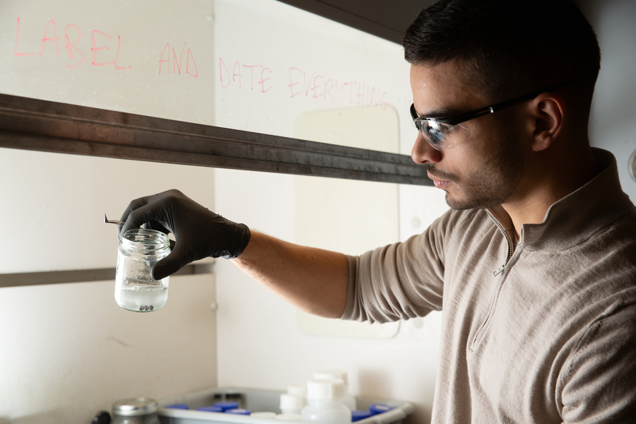 Caption:Aly Kombargi holds a jar of aluminum pellets as they start to react in seawater. Credits:Photo: Tony Pulsone