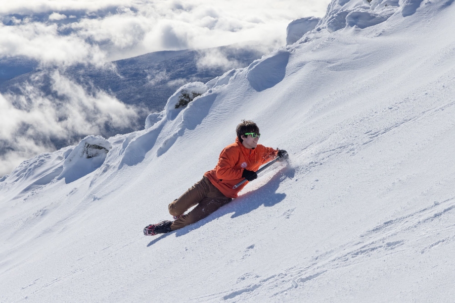 Timur Uyumaz uses an ice axe to arrest his slide down a snow-covered slope