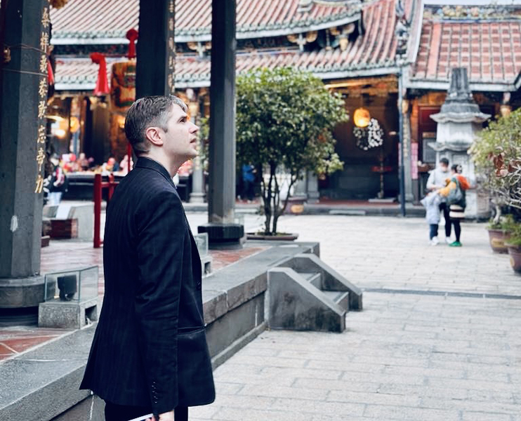 Tristan Brown strolls through a plaza at the Dalongdong Bao'an Temple in Taipei, Taiwan.
