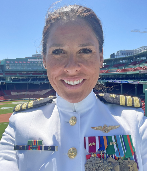 Jennifer Huck takes a selfie in her white naval dress uniform at Fenway Park, with four medals and two ribbons visible
