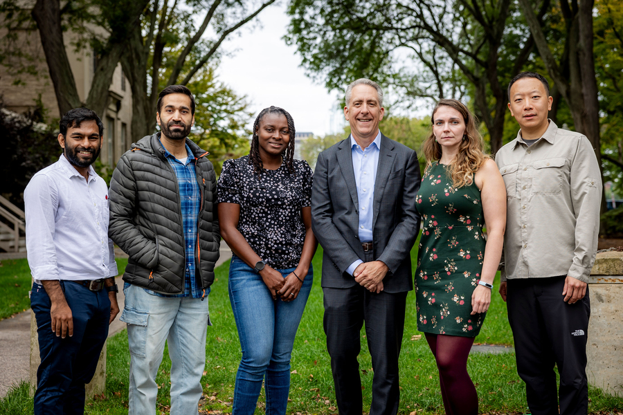 Past and current Postdoctoral Association officers stand outside with Vice President for Research Ian Waitz.