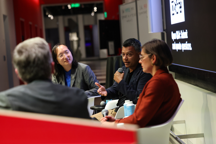 Four people talking on a panel