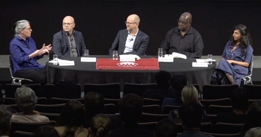 Katrina Burgess, Daniel Ziblatt, Evan Lieberman, John Githongo, and Prerna Singh sit around a long oval table in front of an audience.