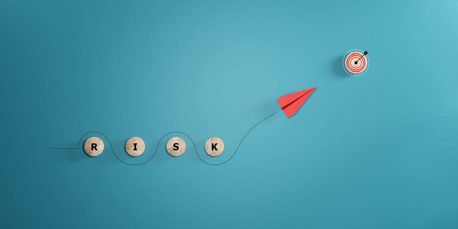 A red paper plane pointed at a bullseye, leaving a dotted line in its wake, which weaves around the letters "R-I-S-K"