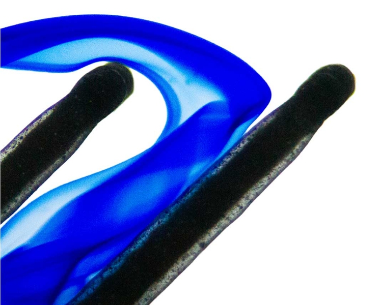 Blue liquid whips through an opening.