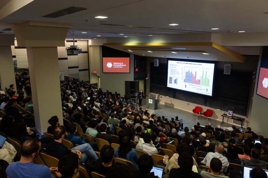 View of a full lecture hall from the back row