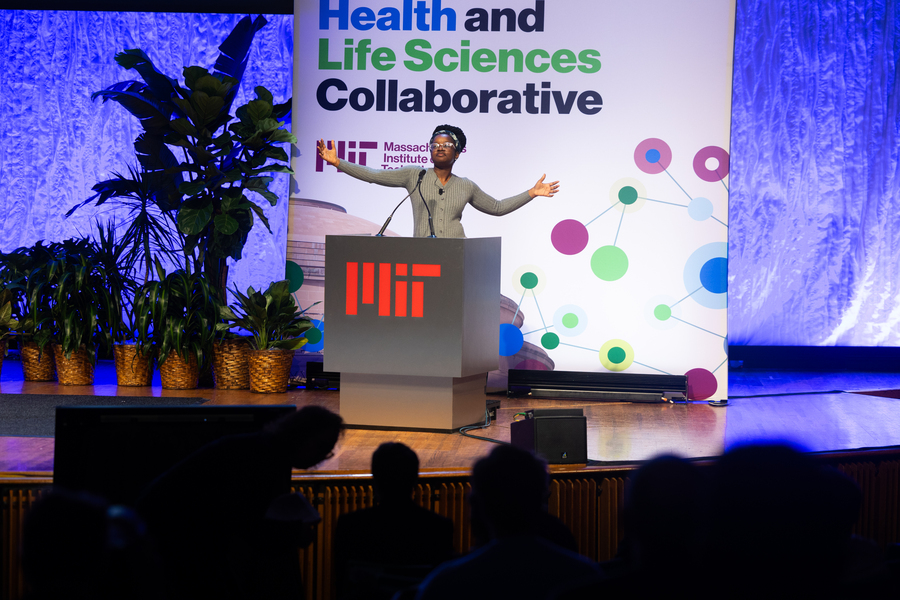 Victory Yinka-Banjo on stage, arms outstretched.