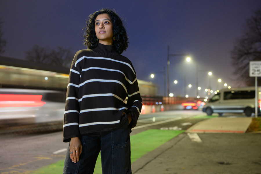 Shreyaa Raghavan poses in front of a nighttime traffic scene