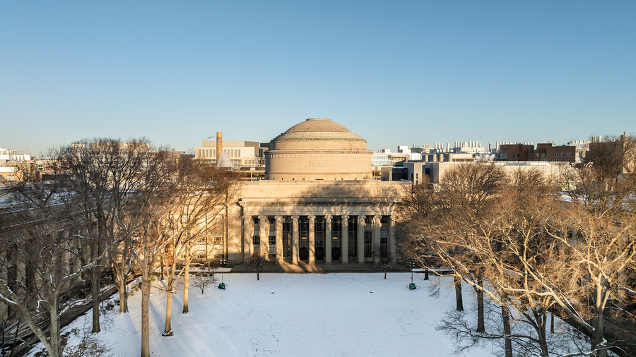 Aerial photo of MIT building 10 and Killian Court with snow on the ground