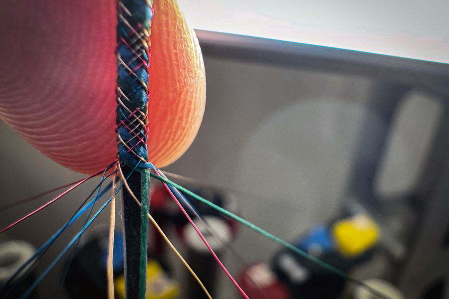 Braiding a computer fiber with a combination of metal and textile yarns