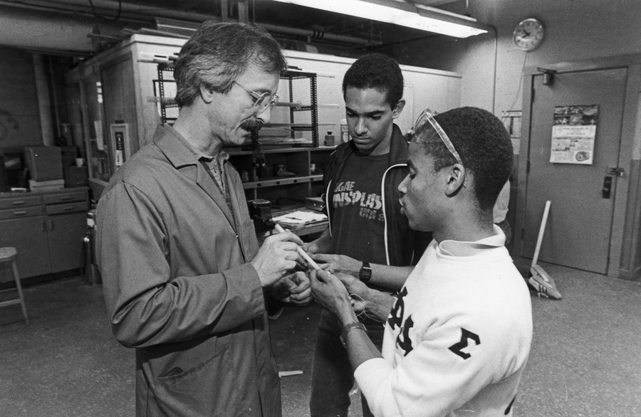 Professor Woodie Flowers talks with two students in an MIT lab in the mid-1980s